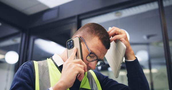 frustrated network engineer speaking on a cell phone